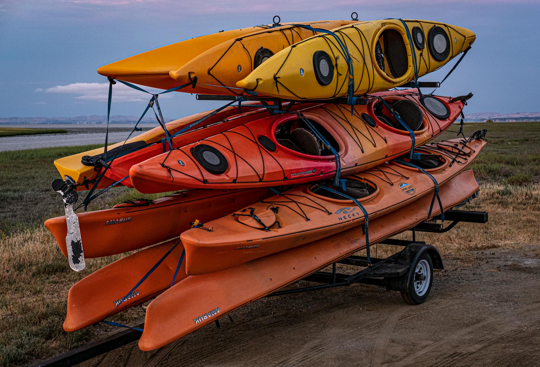 Kolorowe kajaki załadowane na przyczepę przed spływem
